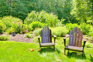 photo of two adirondack chairs in a backyard