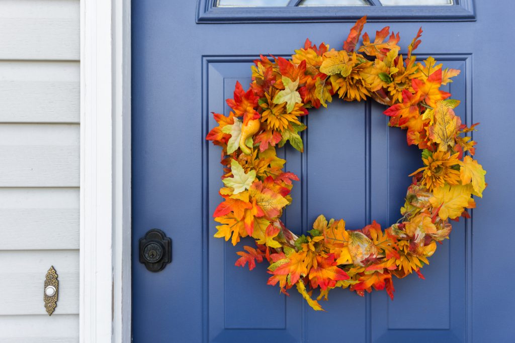 Closeup of exterior door with decorative autumn wreath