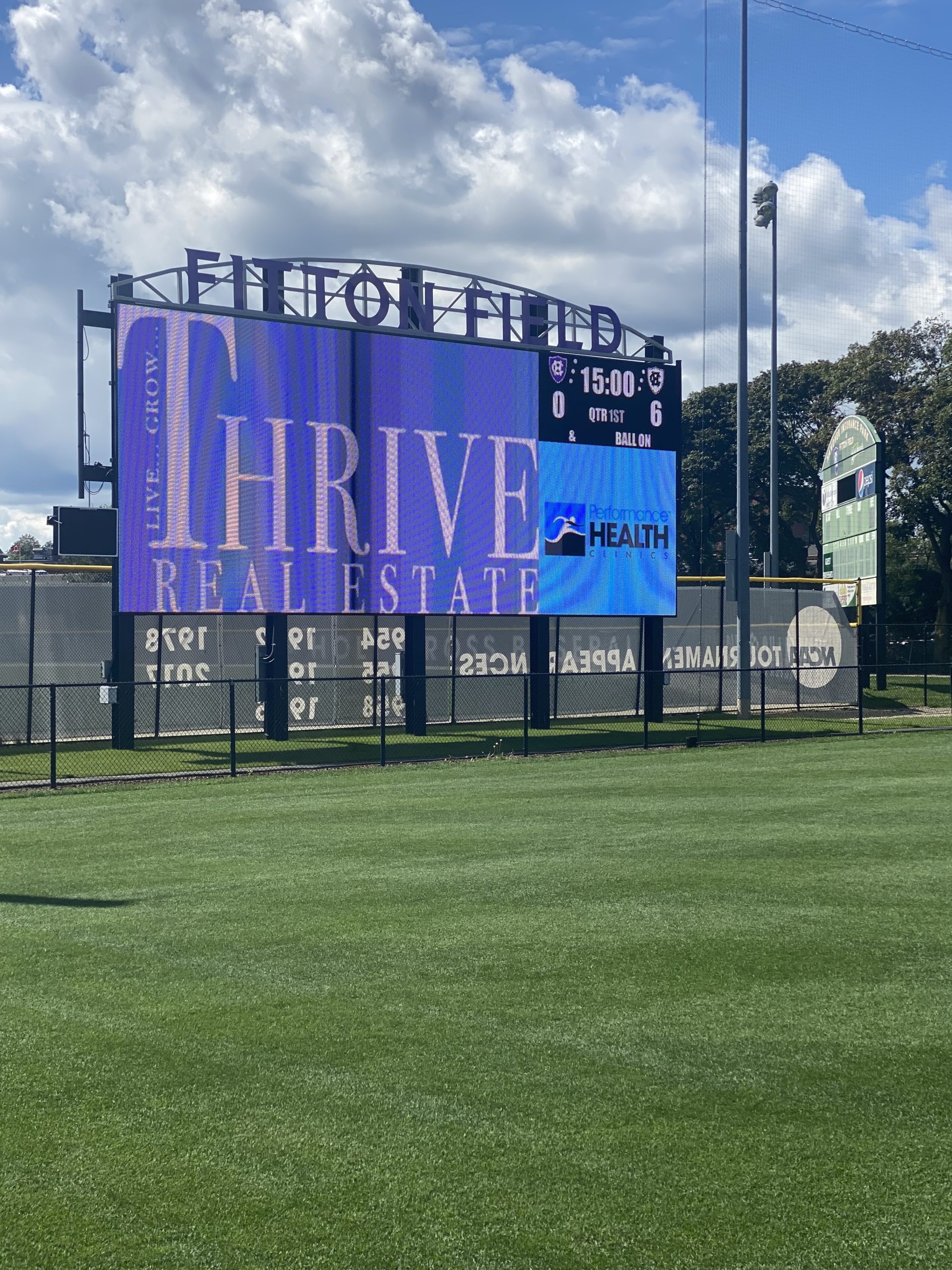 Thrive Real Estate- logo on football scoreboard as official sponsor for Holy Cross